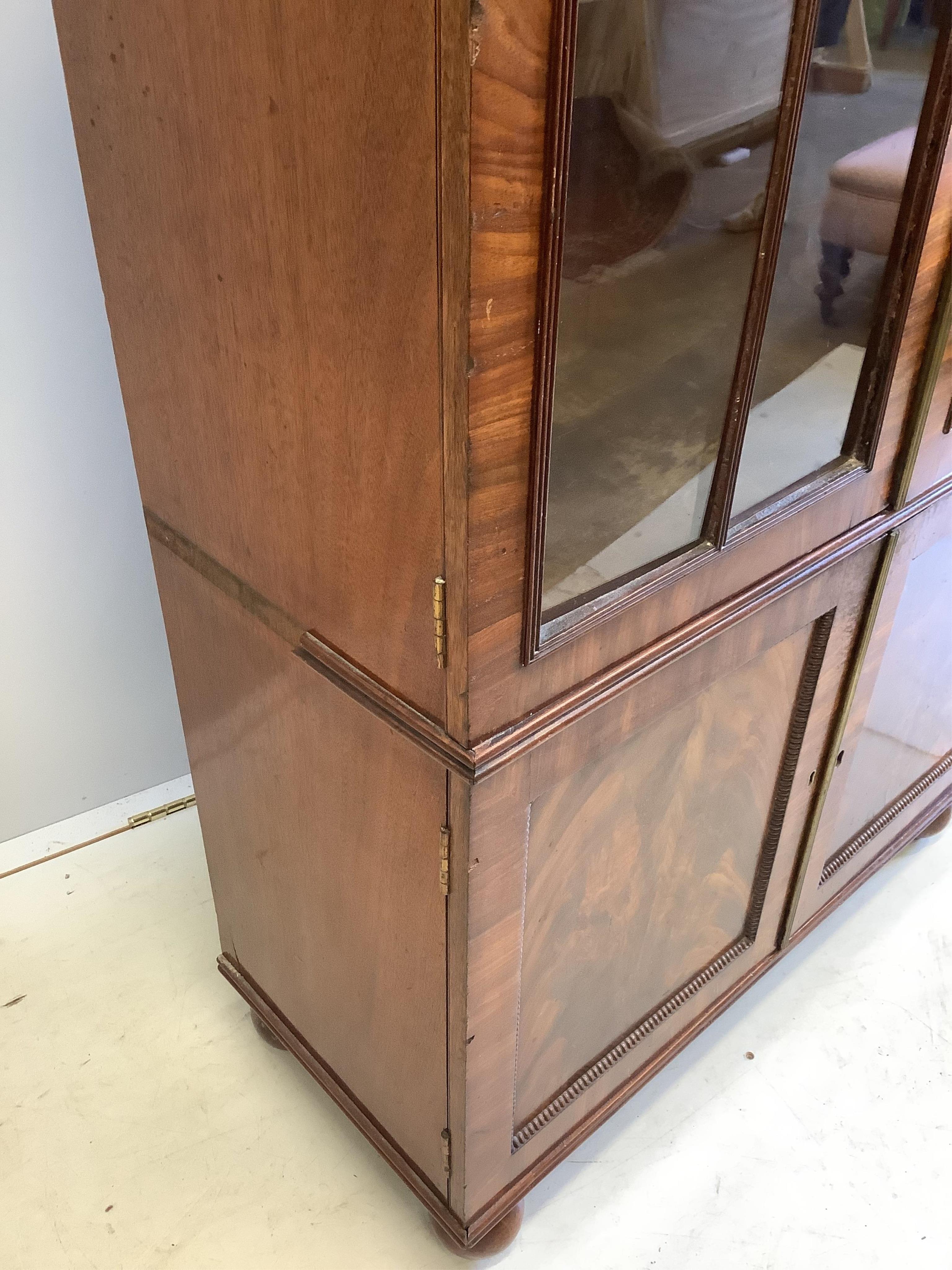 A Georgian style mahogany bookcase cupboard, width 79cm, depth 34cm, height 166cm. Condition - fair